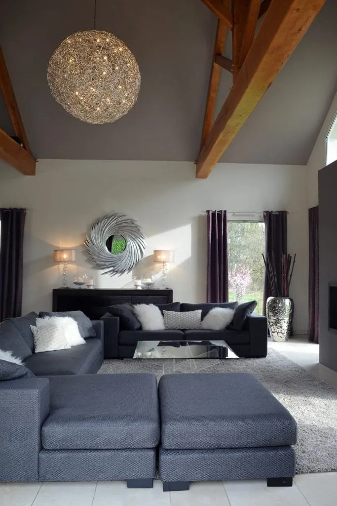 Living room of a home in Rhône-Alpes, Catellani & Smith spherical pendant under exposed beams