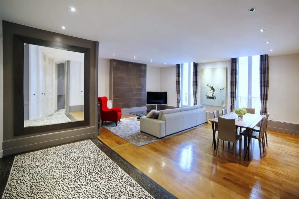 Living and dining area seen from the mosaic hallway with its large mirror, Grenoble apartment