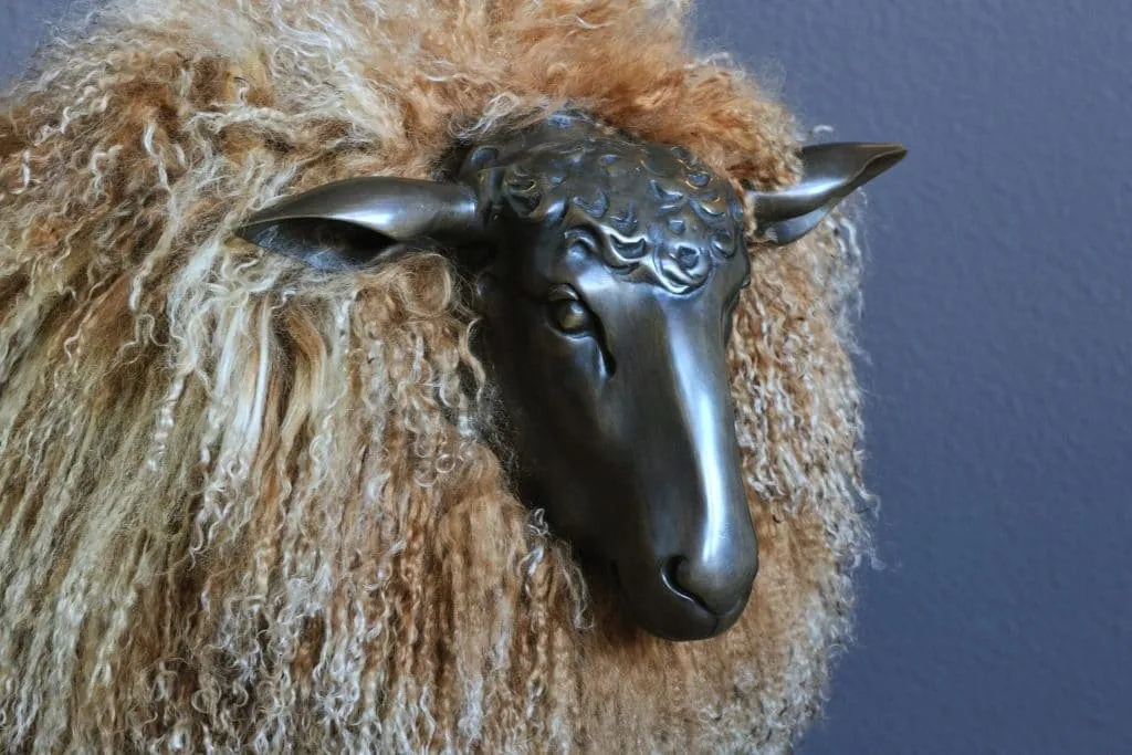 Decorative sheep with a curly fleece and a patinated metal head
