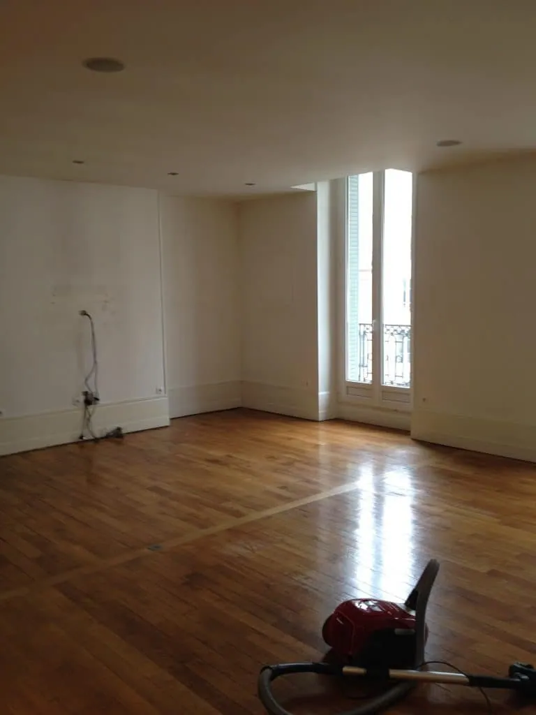 Before the project: empty room with bare walls and parquet floor, Grenoble apartment