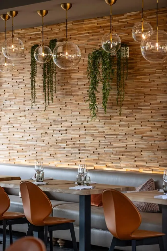 Glass globe pendant lights above the set tables at Le 205